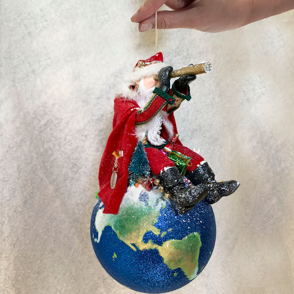 Santa on top of the world planning his Christmas adventure - Red& Green Striped outfit, red cape brimming with presents for children the world wide.-Hanging ornament-kenfolks